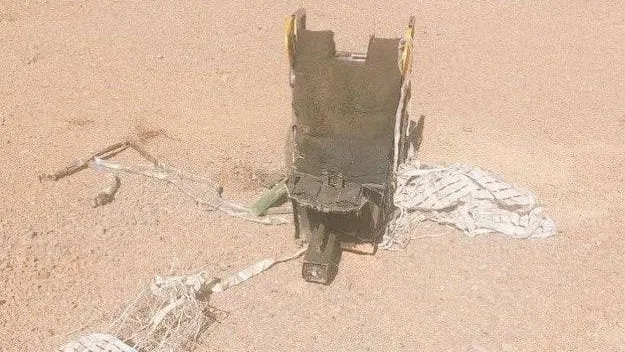 مظلّة ومقعد مقذوف على الأراضي الإيرانية في منظر صحراوي (وسائل إعلام إيرانية)